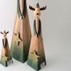 Contemporary design wooden reindeer with green details and a gold glitter star