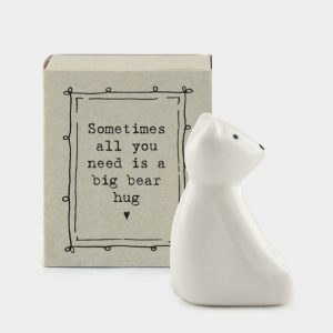 A sweet little porcelain bear keepsake kept in a little cardboard matchbox with the wording 'SOmetimes all you needs is a big bear hug' printed on it.