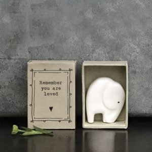 A sweet little ceramic elephant keepsake stored in a little cardboard matchbox with the words 'Remember you are Loved' printed on it.