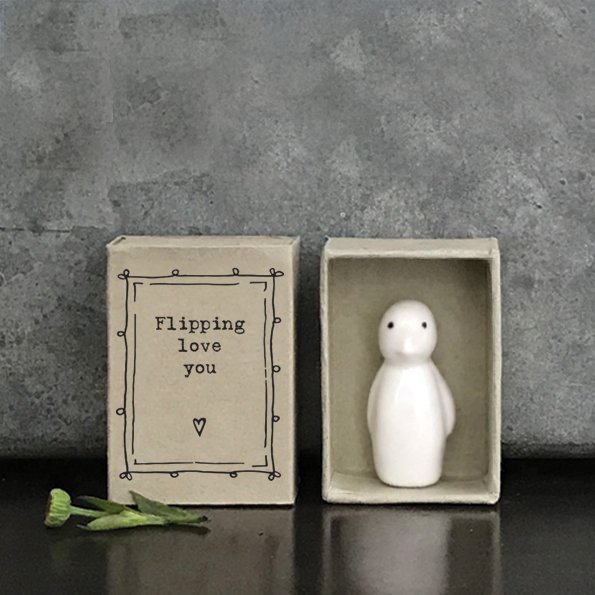 A sweet little porcelain penguin keepsake kept in a little cardboard matchbox with the wording 'Flippin Love You' printed on it.