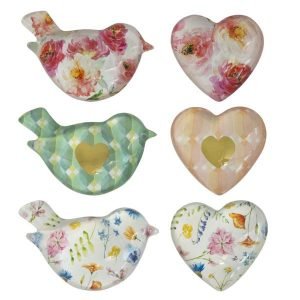 A collection of different designed paperweights in either a bird or a heart shape