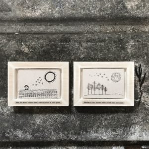 A beautiful framed embroidered piece of felt with an image of trees, birds and the sun. The wording 'Feathers will appear, when loved ones are near' printed on it.