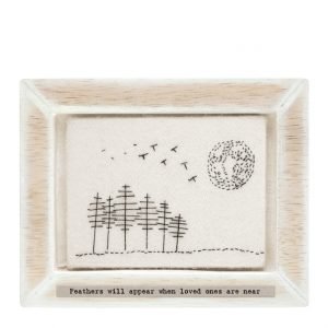 A beautiful framed embroidered piece of felt with an image of trees, birds and the sun. The wording 'Feathers will appear, when loved ones are near' printed on it.