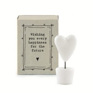 A little ceramic keepsake of a heart on a stick in a pot, with a cardboard matchbox with the wording 'Wishing you every happiness for the future.'
