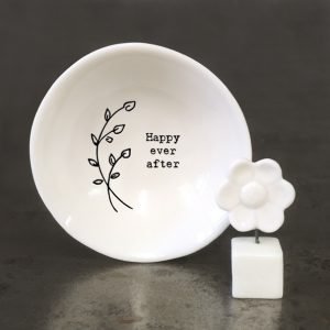 A sweet little white ceramic flower in a pot keepsake in a cardboard matchbox with the words 'Thinking of You' printed on it.