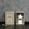 A cute little white ceramic star on a little ceramic cube which is presented in a matchbox with the words Happy Birthday printed on it.