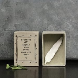 A beautiful white ceramic feather keepsake with a cardboard matchbox with the wording Feathers will appear when loved ones are near printed on it.