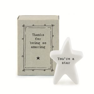 A lovely porcelain star with You're a star written on it. The star is stored in a cardboard matchbox with the words 'Thanks for being so Amazing' printed on it.