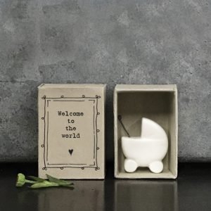 A lovely little ceramic keepsake of a babies pram. The keepsake is kept in a cardboard matchbox with the words Welcome to the World printed on it.