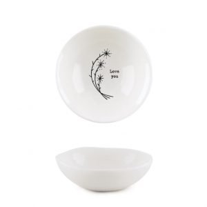 A white ceramic dish from design company East of India with a flower design and the words 'Love You' imprinted in the middle of it.