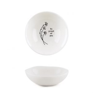 A mini white ceramic trinket dish with a flower design and the words 'So Proud of You' imprinted on it.