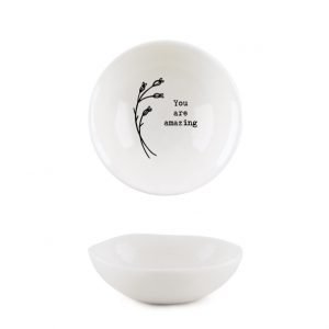 A sweet little white trinket dish withe a flower design and the words 'You are Amazing' imprinted on it.