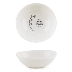 A sweet white ceramic dish from British design company East of India, with a flower design and the wording 'The Secret Ingredient is Always Love' imprinted on it.
