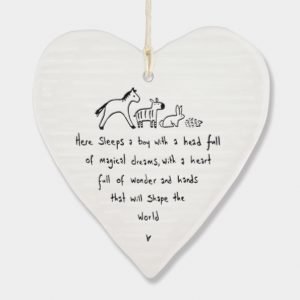 A white ceramic wobbly heart from British design company East of India. The words Here sleeps a boy with a head full magical dreams, a heart full of wonder and hands that will shape the world' imprinted on it.