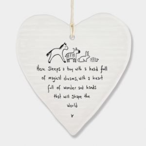A white ceramic wobbly heart from British design company East of India. The words Here sleeps a boy with a head full magical dreams, a heart full of wonder and hands that will shape the world' imprinted on it.