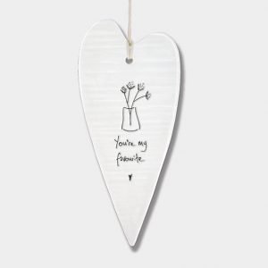 A long ceramic hanging heart from British design company East of India with an image of a vase of flowers and the words 'You're My Favourite' imprinted on it.