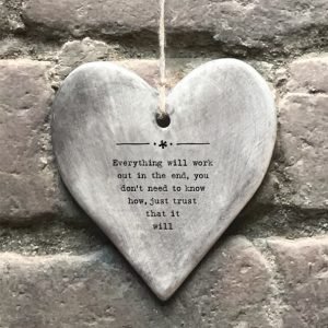 A grey rustic glazed hanging heart with the wording ' Everything will work out in the end, you don't need to know how, you just need to trust that it will.' imprinted on it.