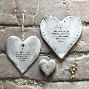 A rustic grey hanging heart with the words ' Live life to the fullest, love with all your heart and laugh often.