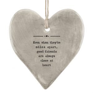 A grey rustic hanging heart from East of India with the wording 'Even when they're miles apart, good friends are always close at heart'
