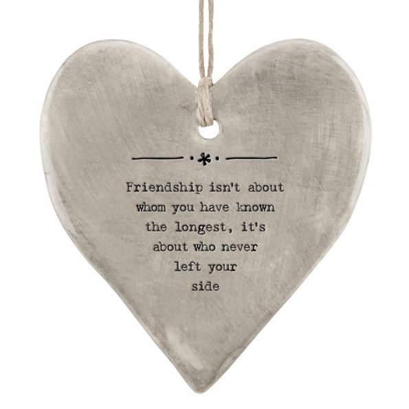 A grey rustic hanging heart with rope hanger and with the words 'Friendship isn't about whom you've know the longest, it's about who never left your side.'