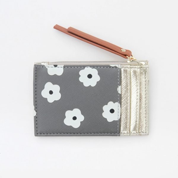 A stunning daisy design cardholder and coin purse from British designer Caroline Gardner. WIth a grey background, white flower with a black centre and with a gold envelope top to it.