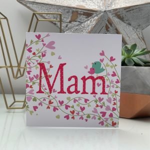 A lovely card from Wotmalike with Mam printed in the centre of the card with a couple of birds sitting on the last letter M. There are hearts and flowers all around the wording.