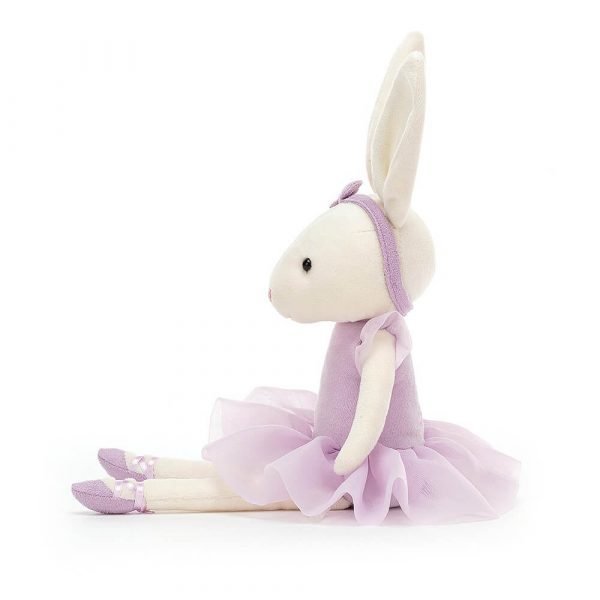 A cream velveteen ballerinaballerina bunny soft toy in a lilac tutu and matching headband