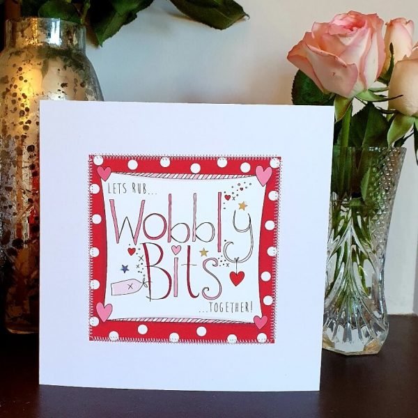 A valentines day card with the words Lets rub wobbly bits together hand finished with little silver stars and hand stitching.