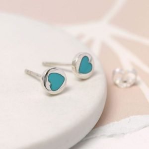 A pair of small sterling silver turquoise heart earrings.