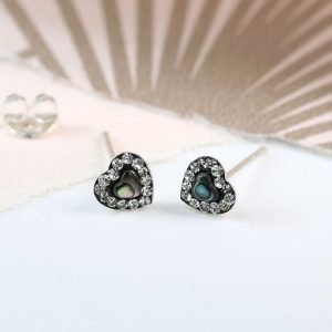 A pair of sterling silver paua shell heart studs with crystals.