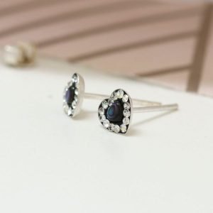 A pair of sterling silver paua shell heart studs with crystals.
