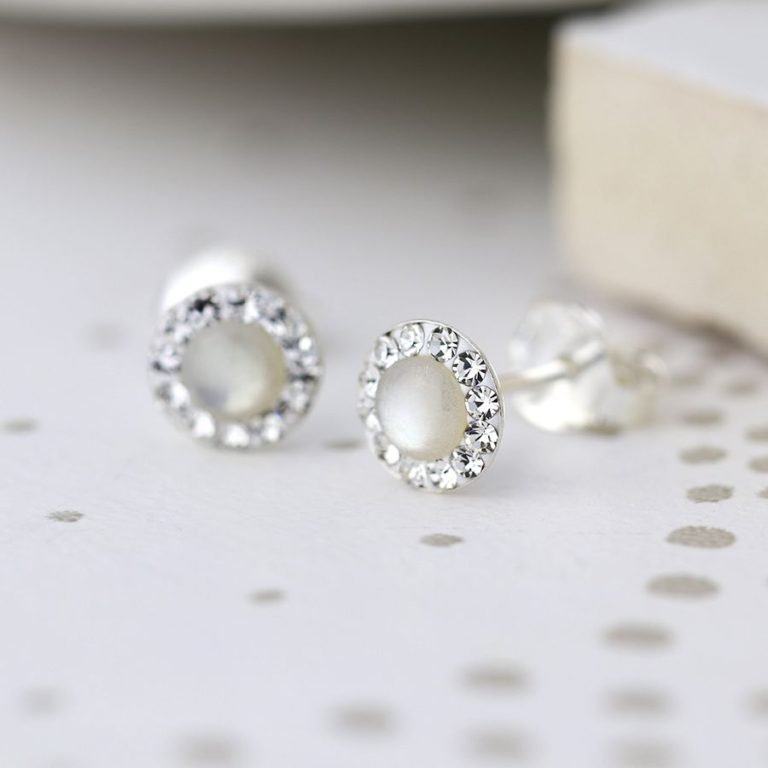 A pair of sterling silver pearl and crystal studs. The studs have a pearl centre which is surrounded by tiny crystals around the edges.