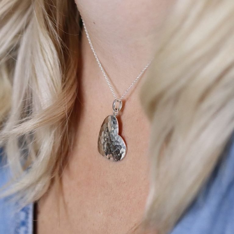 A beautiful hammered heart pendant on a silver chain