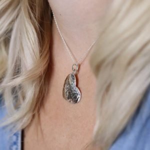 A beautiful hammered heart pendant on a silver chain