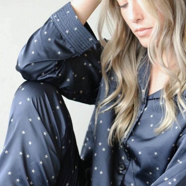 Navy ladies pyjama set printed with contrasting little stone coloured stars. Luxury pyjamas with a long sleeved button up shirt and long drawstring trousers.
