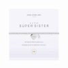 An elasticated bracelet from Joma with round silver plated brass beads and a silver heart pendant stamped with Sister from Joma. Presented on a white card printed with A little Super Sister - this special heart is just for you because you're my sister and I love you