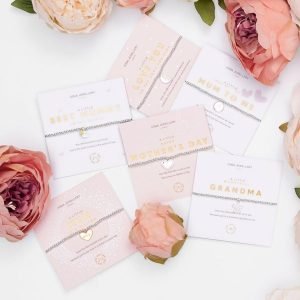 A silver plated bead stretch bracelet with an embellished gold heart charm from Joma Jewellery. The bracelet is presented on a pink coloured card with the wording A Little Mum in a Million printed on it.