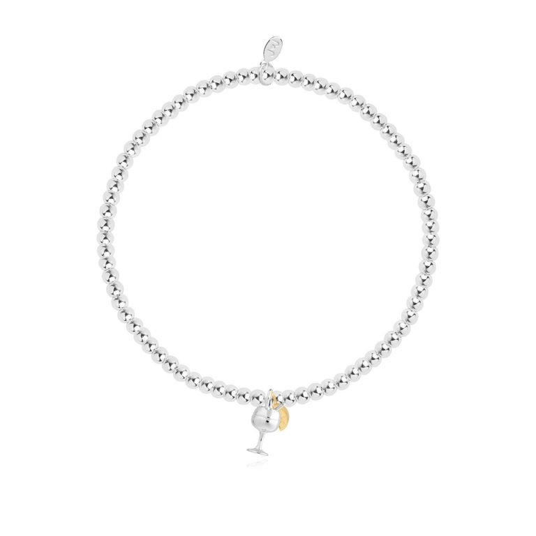 A silver plated stretch bracelet with a charm of a gin glass. The bracelet comes on a white sentiment card with the wording 'WHen life gives you lemons Grab a G&T' printed on it.