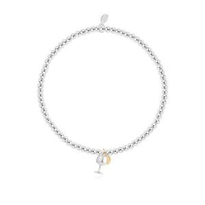 A silver plated stretch bracelet with a charm of a gin glass. The bracelet comes on a white sentiment card with the wording 'WHen life gives you lemons Grab a G&T' printed on it.