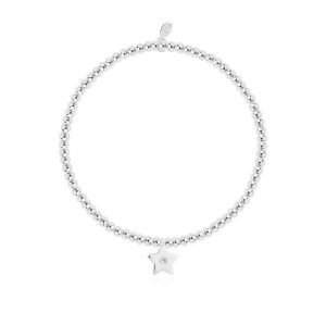 A silver plated bead stretch bracelet with a silver star with crystal on it from Joma Jewellery. The bracelet is presented on a pink square card with gold hearts on it.