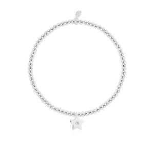 A silver plated bead stretch bracelet with a silver star with crystal on it from Joma Jewellery. The bracelet is presented on a pink square card with gold hearts on it.