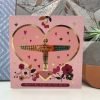 A large square card with a gold foil angel of the North with love you on it. The angel in in a big pink heart with little hearts dotted around, the heart is outlined in gold. The card is pink with flowers and hearts and the words Mam - my angel of the north