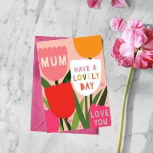 A colourful card with images of tulips and the words Mum Have a lovely day Love You printed on it.