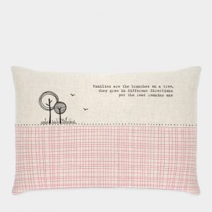 A long cushion with a contemporary design in pink and black and the words, Families are the branches on a tree, they grow in different directions yet the root remains one