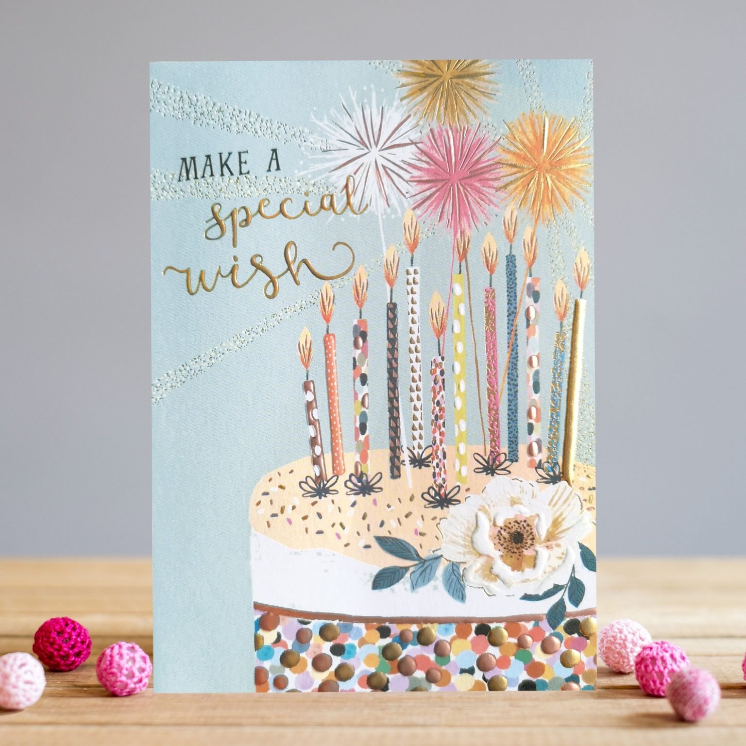 A beautiful card from Louise Tiler. The background is pale blue with and image of a gorgeous birthday cake covered in birthday candles. The words Make a Special Wish are embossed, foiled and printed on the card.