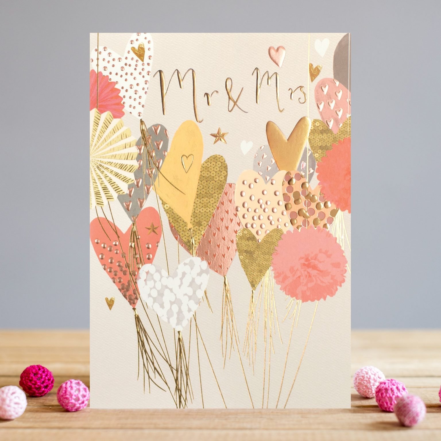 A card from Louise Tiler which is covered in colourful balloons with the words Mr & Mrs embossed foiled and printed on it.
