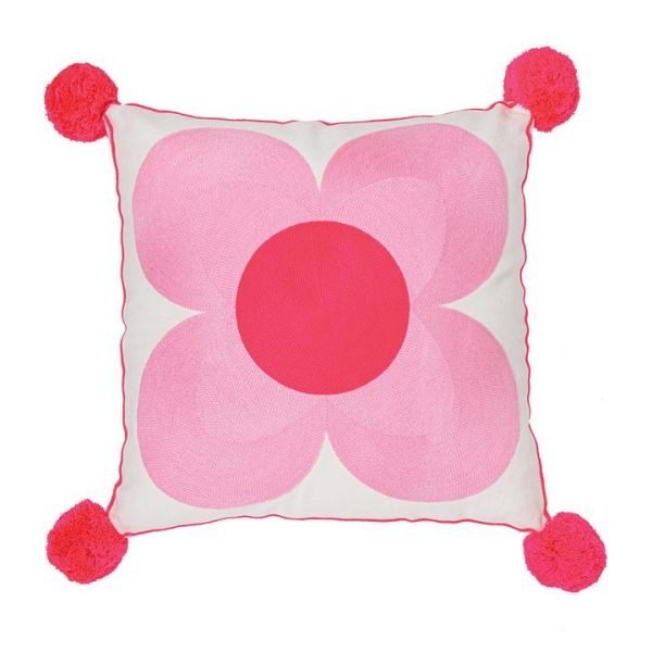 A large cotton cushion with a red pom pom at each corner and an embroidered flower that fills the front cover. The flower has 4 pale pink petals and a large red centre. Removeable cover and polyester filled inner made from recycled plastic bottlesA