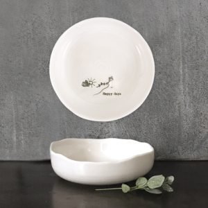 A white porcelain trinket dish printed on the bottom in black hand drawing of a sun, cloud and kite flying and the words Happy Days