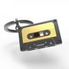 A grey and gold metal cassette tape keyring
