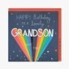A dark navy card with spots and stars and the words Happy Birthday to a lovely Grandson have fun. Grandson is in rainbow letters